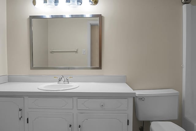 bathroom featuring vanity and toilet