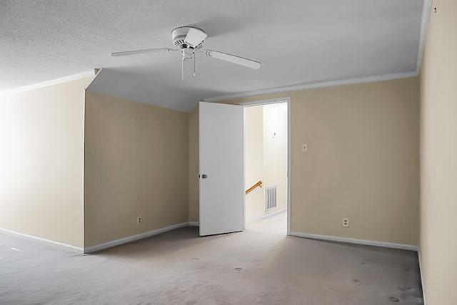 interior space with ceiling fan, light colored carpet, and a textured ceiling