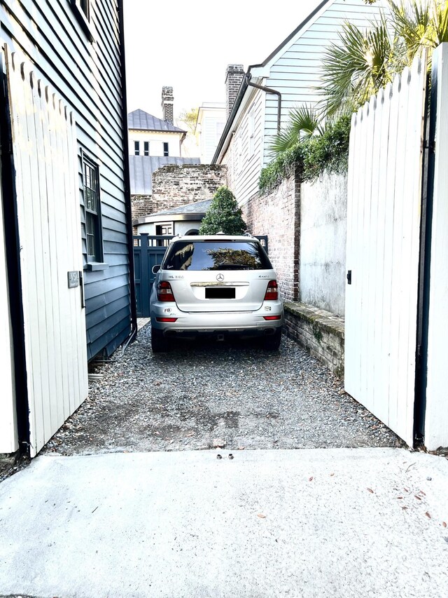 view of vehicle parking with fence