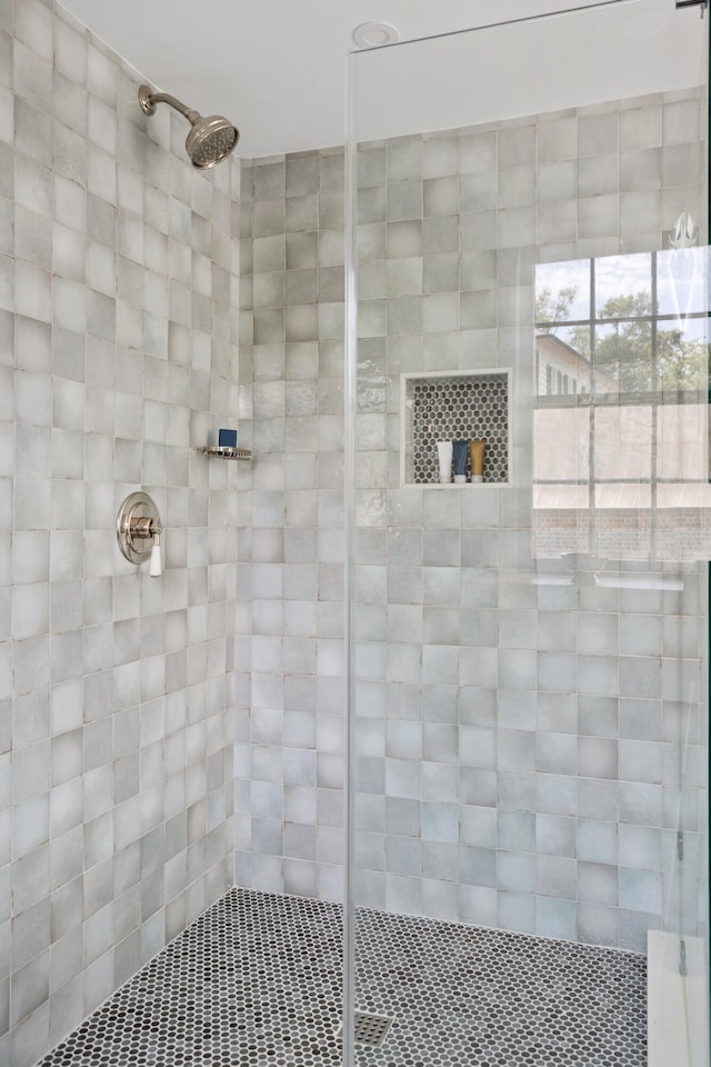 bathroom with a tile shower