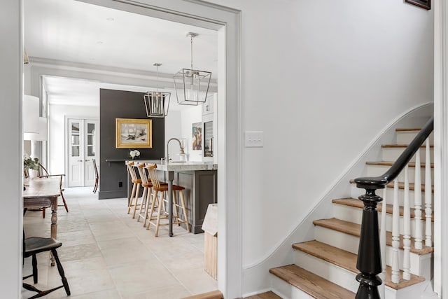 staircase featuring french doors and tile patterned flooring