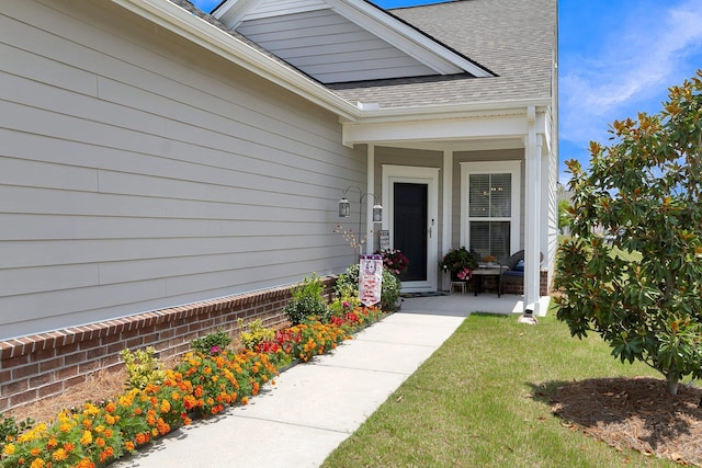 entrance to property featuring a yard