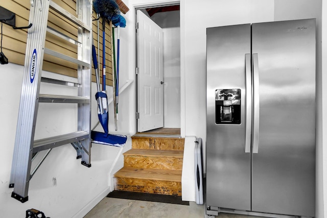 stairway with concrete flooring