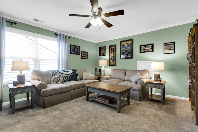 living room with crown molding, carpet floors, and ceiling fan