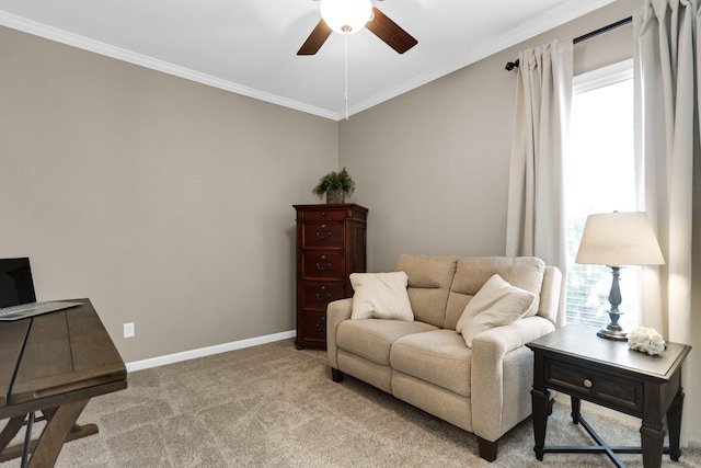 living area featuring crown molding, carpet flooring, and ceiling fan