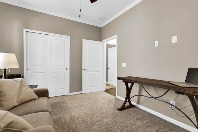 carpeted office space featuring ornamental molding and ceiling fan