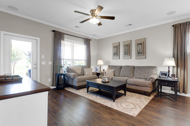 living room featuring ceiling fan, ornamental molding, and dark hardwood / wood-style floors