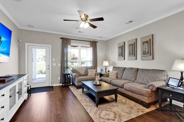 living room with ornamental molding, dark hardwood / wood-style floors, and ceiling fan