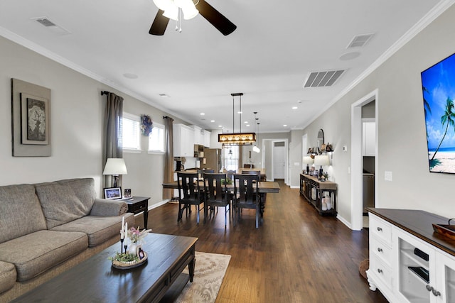 living room with ornamental molding, dark hardwood / wood-style floors, and ceiling fan