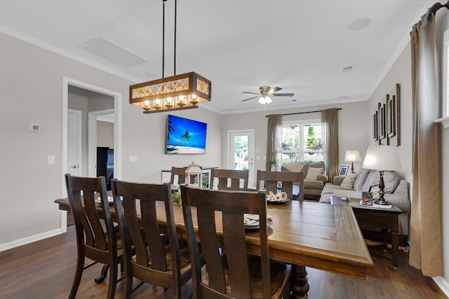 dining space featuring crown molding, ceiling fan, and dark wood-type flooring