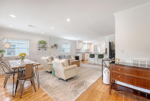 4587 Durant Ave, North Charleston, SC 29405 - living area with ornamental molding, recessed lighting, light wood-style floors, healthy amount of natural light, and baseboards