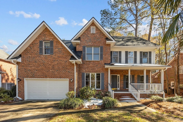 view of front of property with a porch and a garage