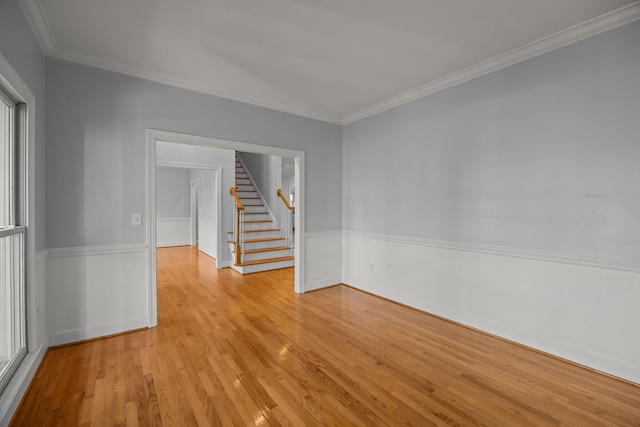 unfurnished room featuring light hardwood / wood-style flooring and ornamental molding