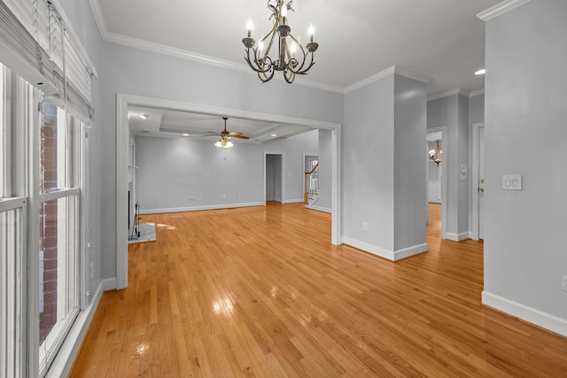 unfurnished living room with crown molding, ceiling fan with notable chandelier, and light hardwood / wood-style floors