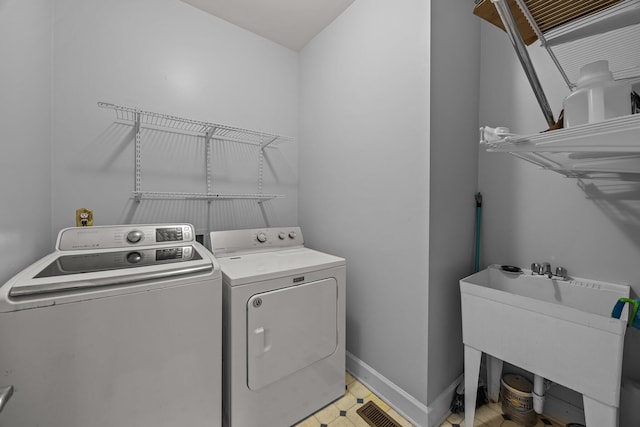 washroom featuring sink and washer and dryer