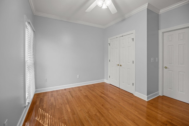 unfurnished bedroom with ornamental molding, a closet, ceiling fan, and light hardwood / wood-style flooring