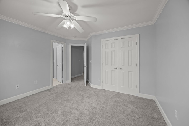 unfurnished bedroom with ceiling fan, light colored carpet, ornamental molding, and a closet