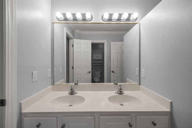 bathroom featuring crown molding, vanity, and toilet