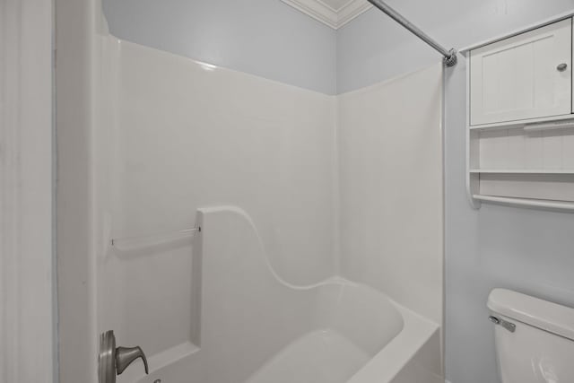 bathroom with bathing tub / shower combination and toilet