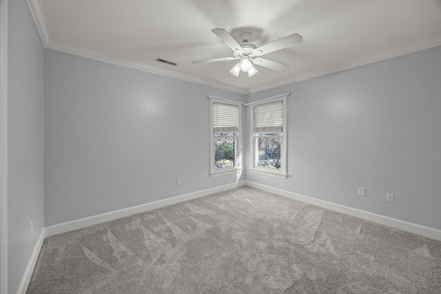 empty room with ceiling fan, ornamental molding, and carpet flooring