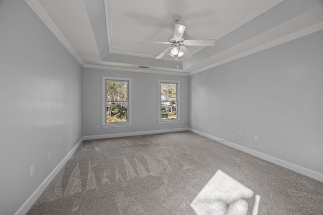 spare room with crown molding, carpet, ceiling fan, and a tray ceiling