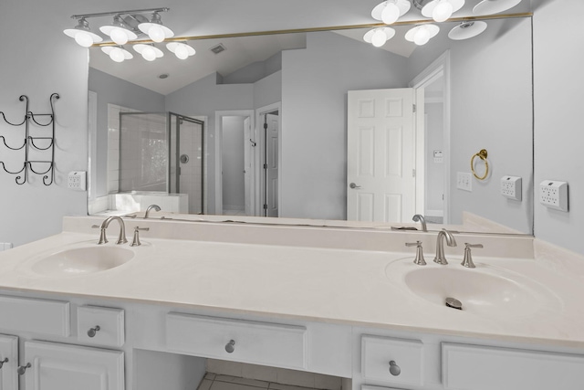 bathroom with vanity, vaulted ceiling, and a shower with door