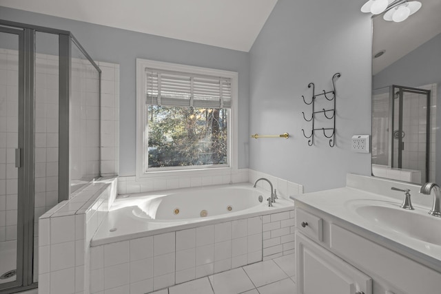 bathroom featuring independent shower and bath, vanity, vaulted ceiling, and tile patterned floors