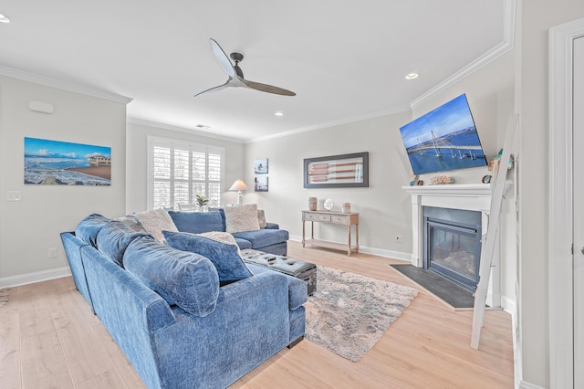 living room featuring crown molding, ceiling fan, and hardwood / wood-style flooring