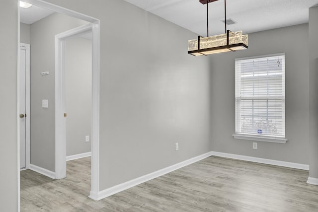 unfurnished dining area with light wood-type flooring