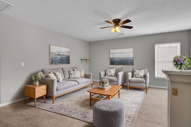 carpeted living room with a textured ceiling and ceiling fan