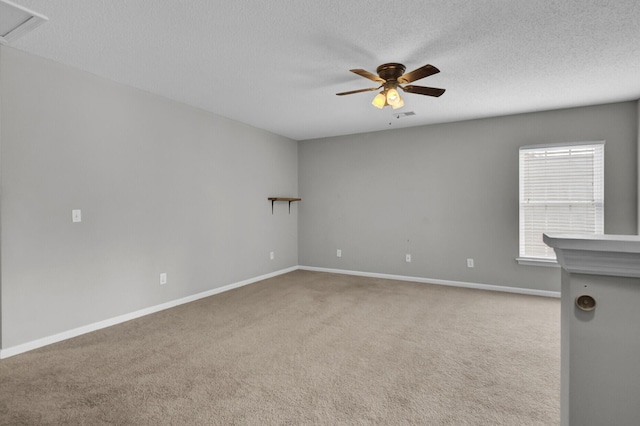 unfurnished room featuring light carpet, a textured ceiling, and ceiling fan