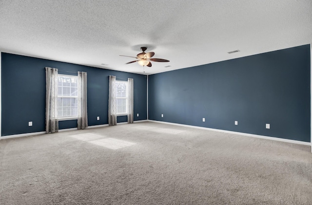 empty room featuring light carpet, a textured ceiling, and ceiling fan