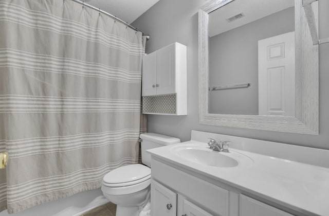 bathroom with vanity, toilet, and walk in shower