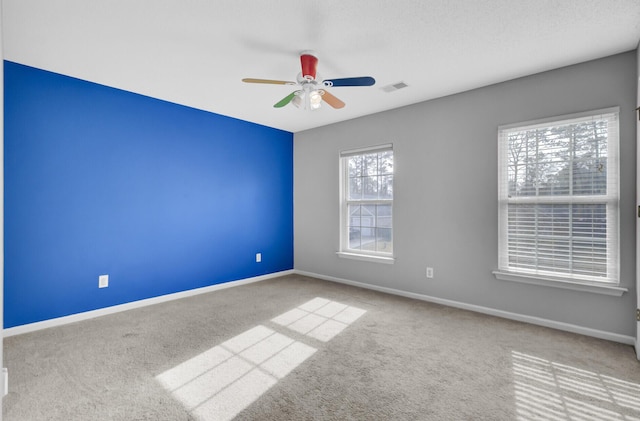 spare room with light colored carpet and ceiling fan