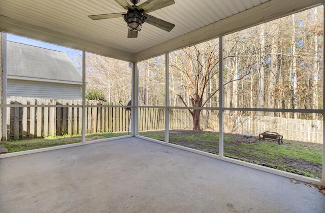 unfurnished sunroom featuring ceiling fan