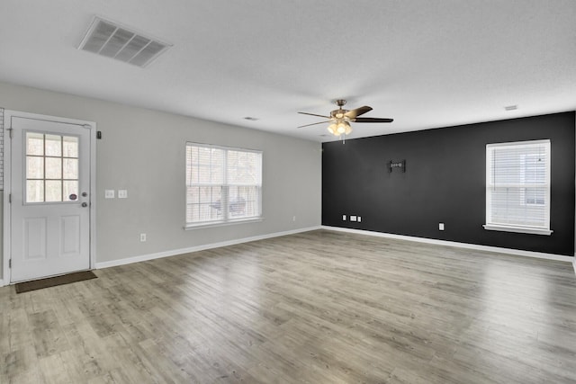 interior space with ceiling fan and light hardwood / wood-style floors