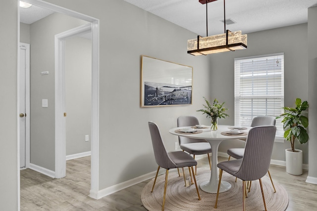 dining space with light hardwood / wood-style flooring