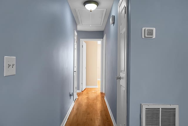 corridor with light hardwood / wood-style flooring