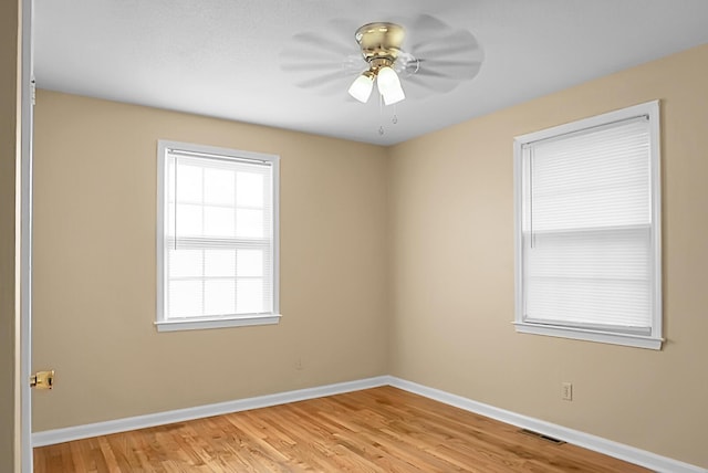 empty room featuring ceiling fan and light hardwood / wood-style floors