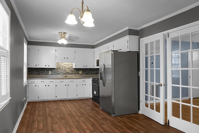 kitchen with white cabinets, pendant lighting, stainless steel fridge, and electric range