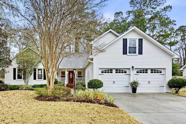 front of property featuring a front yard, a porch, and a garage