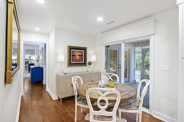 dining area with dark hardwood / wood-style floors