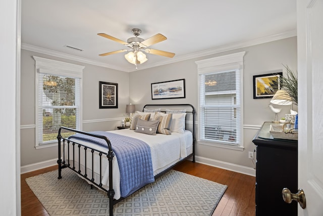 bedroom featuring ceiling fan, crown molding, and dark wood-type flooring