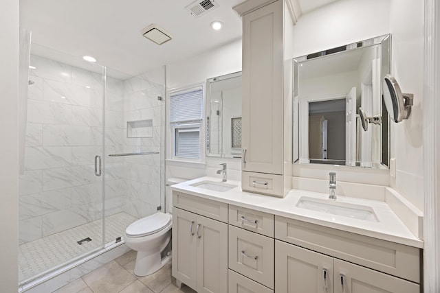 bathroom with tile patterned flooring, vanity, toilet, and a shower with door