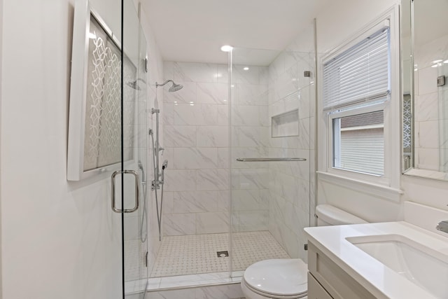 bathroom with vanity, an enclosed shower, and toilet