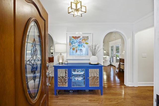 entrance foyer featuring french doors, ornamental molding, and hardwood / wood-style floors