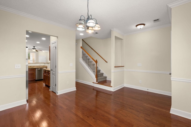 empty room with ceiling fan with notable chandelier, dark hardwood / wood-style flooring, ornamental molding, and a textured ceiling