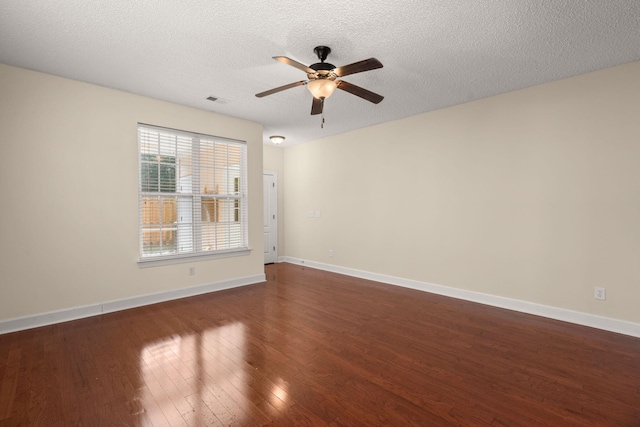 spare room with ceiling fan, dark hardwood / wood-style flooring, and a textured ceiling