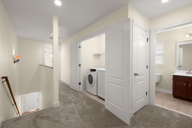 laundry room with light carpet, sink, and washing machine and clothes dryer