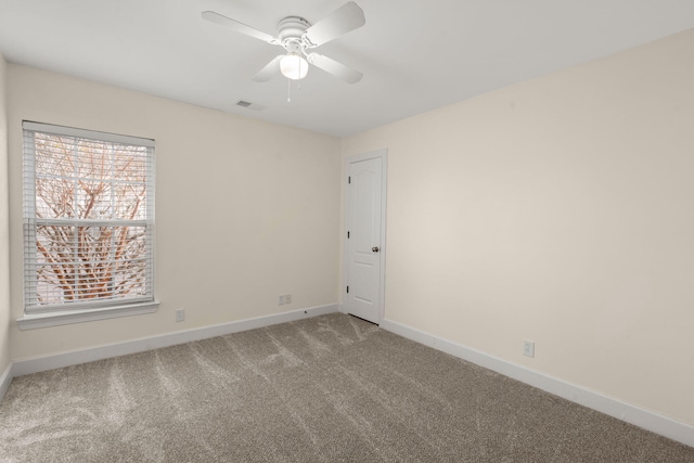 empty room with carpet and ceiling fan